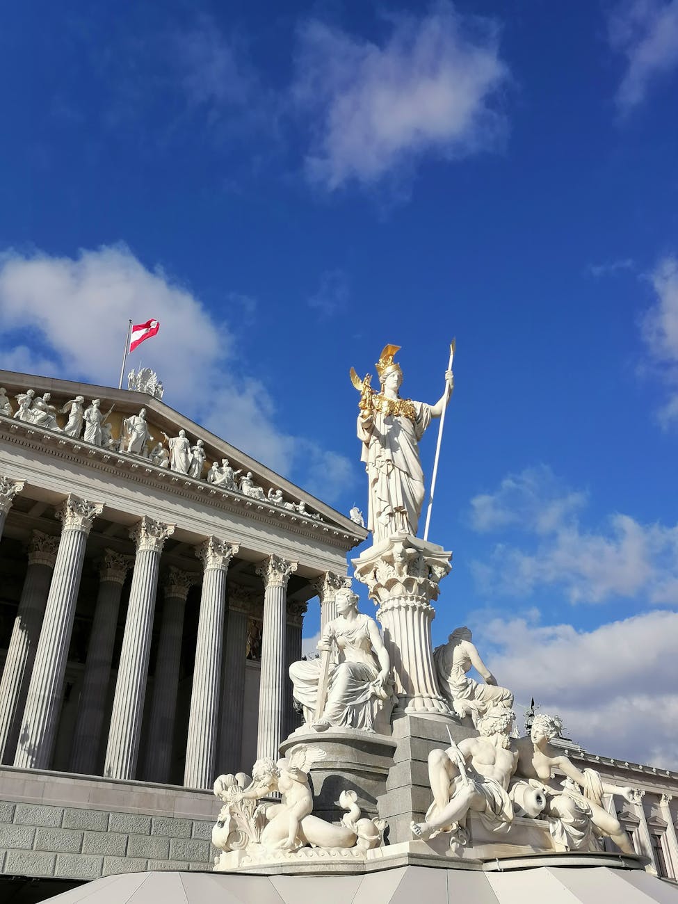 athena statue in front of austrian parliament building
