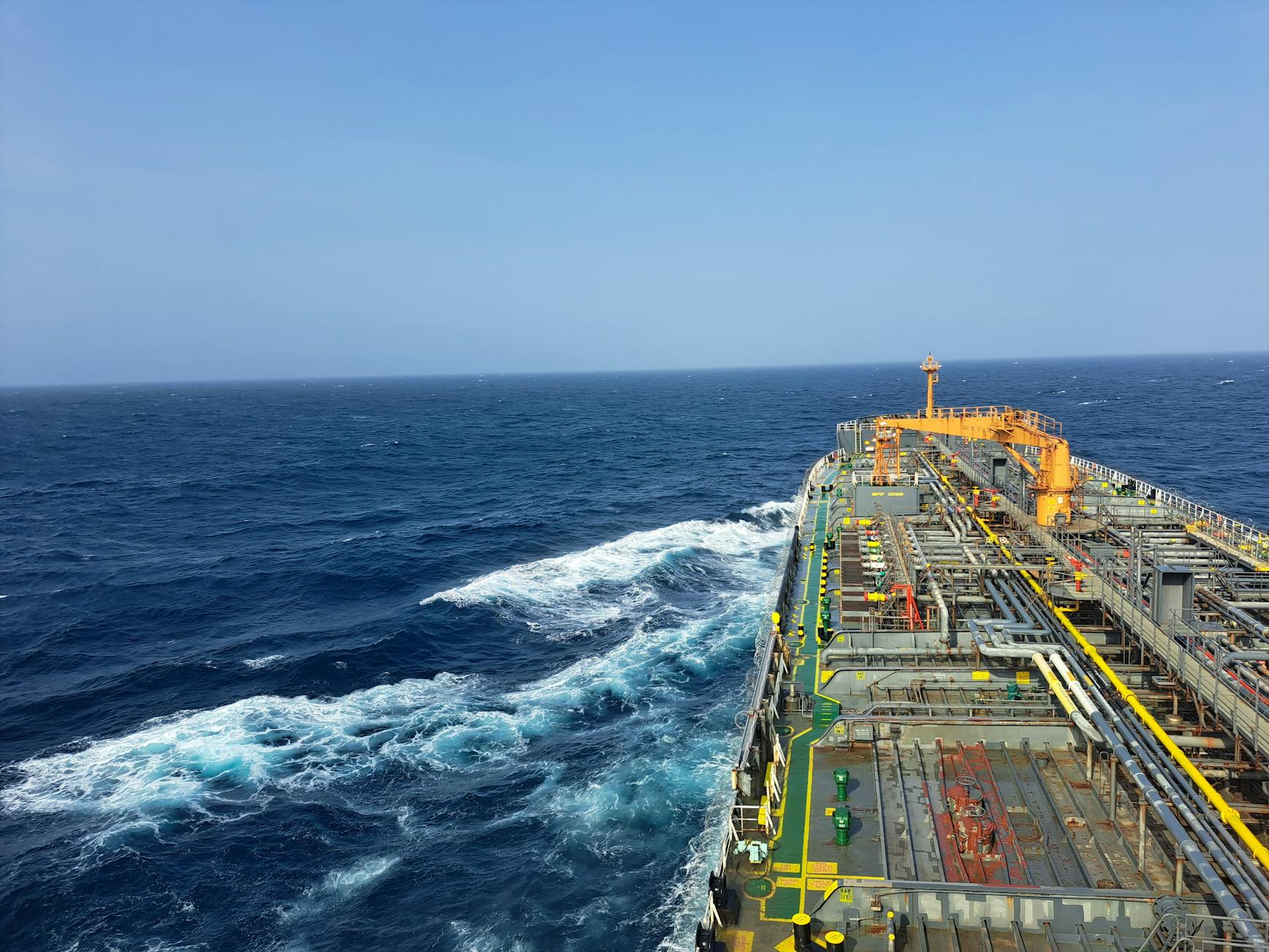 the view from the deck of a ship as it sails through the ocean