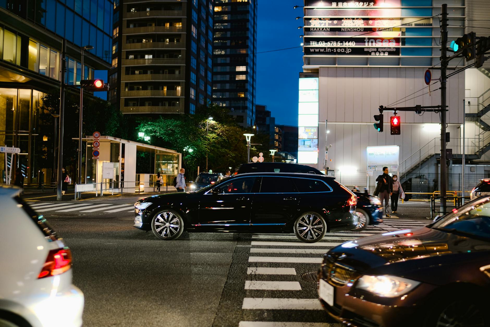 urban night scene at bustling city intersection