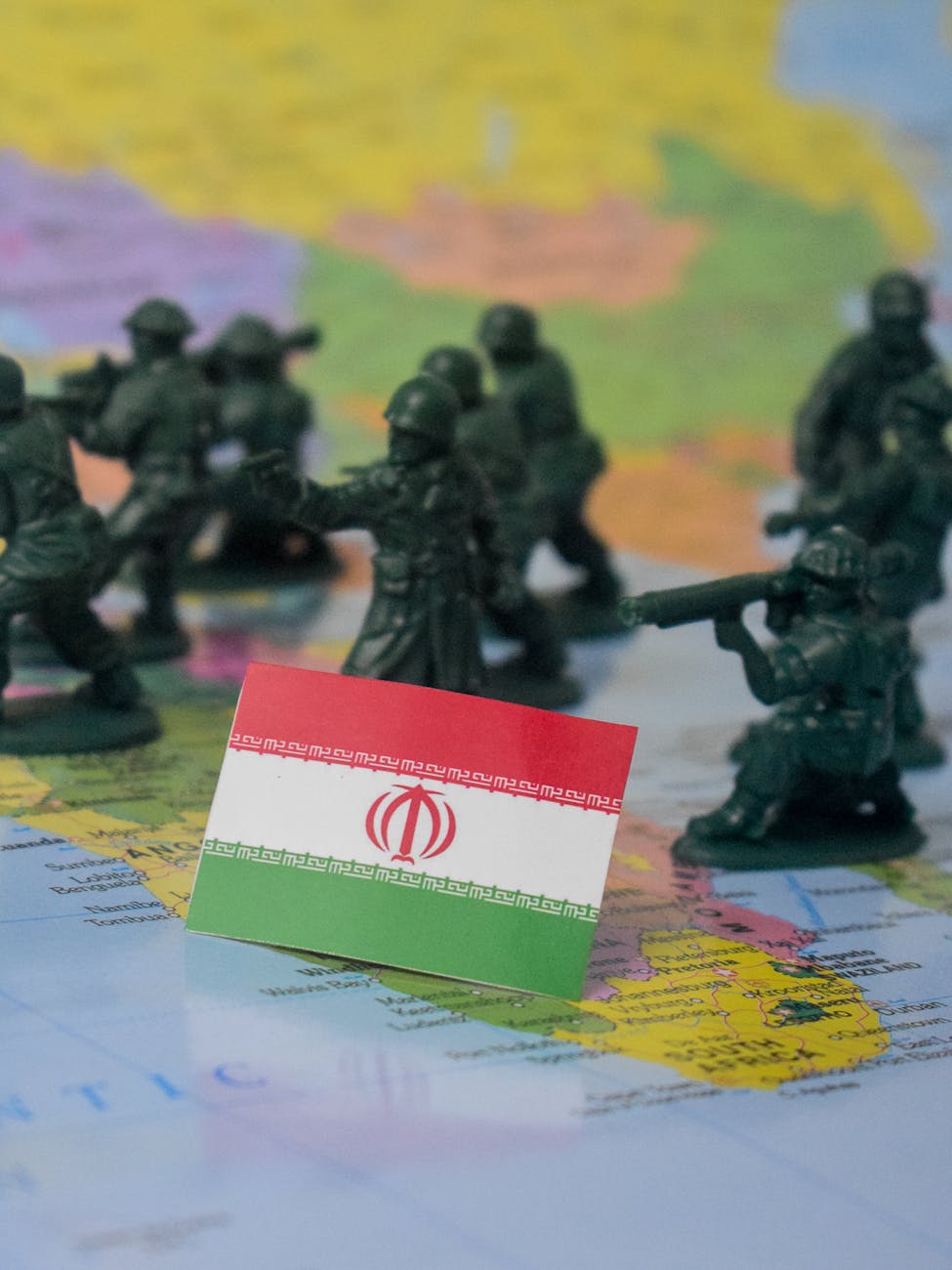 iran flag and toy soldiers on map