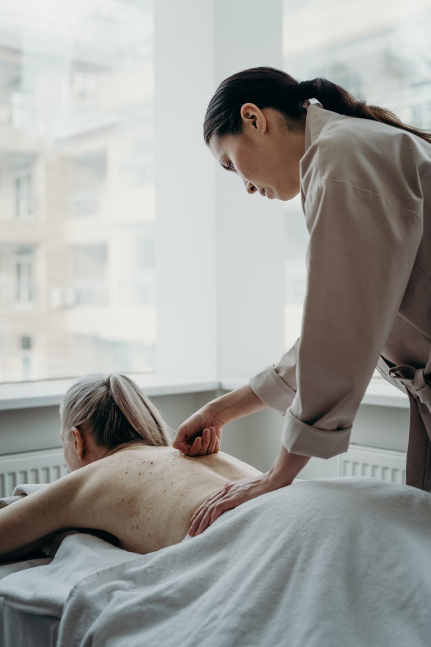 a woman with blonde hair having a back massage
