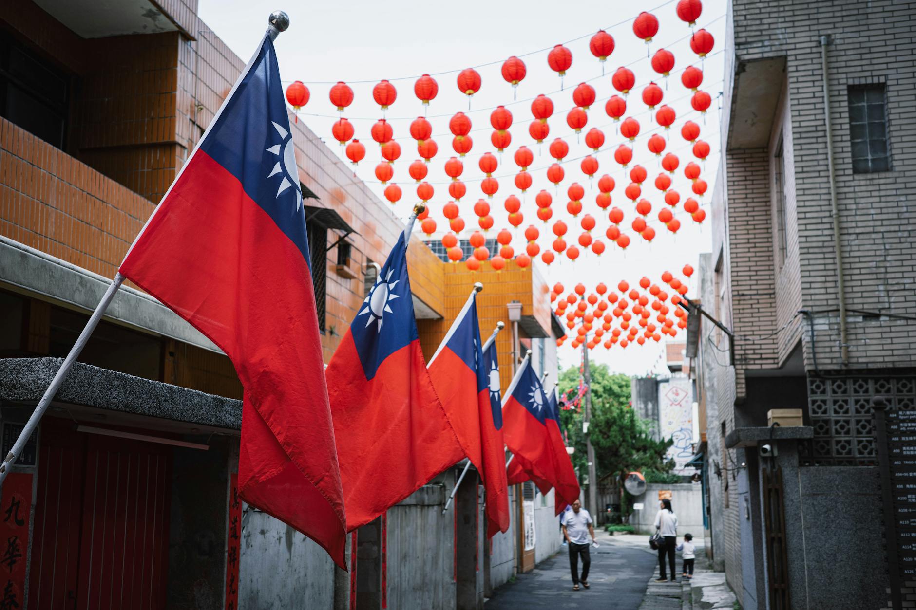 Taiwan’s Opposition Leader Takes a Risky Peace Trip to Beijing .taiwanese flags and lanterns in new taipei alley